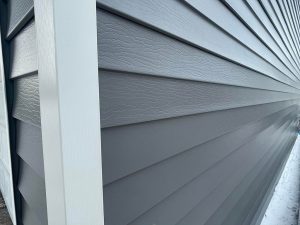 close-up of dark-toned steel lap siding on exterior of home