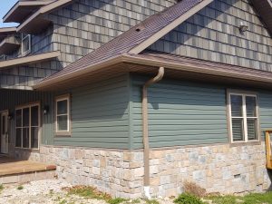 steel lap siding and shake siding on rural home